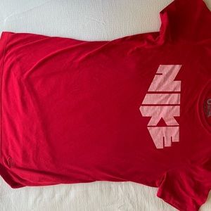 this is a medium red Nike t shirt and it is fitted